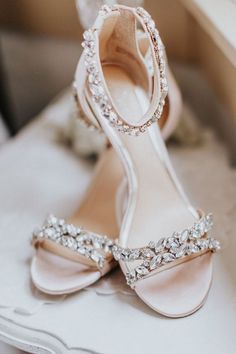 a pair of wedding shoes sitting on top of a table