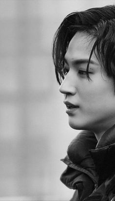 black and white photograph of a young man with his eyes closed, looking off to the side