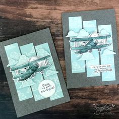 two cards with an airplane on them, one is blue and the other is gray