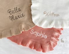 three personalized towels with ruffles on the bottom, one in pink and one in white