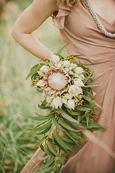 a woman in a dress holding a flower bouquet on her left hand and an instagram button to the right