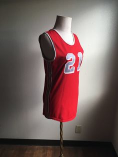 "Vintage spots sleeveless jersey label- Athletic Supply label size 38 (please go by measurements) red with grey and white side stripes and neck stripes 21 patches on front and back good condition w/wear normal to age no fabric info tag feels partly elastic/stretchy measures, lying flat, shoulder- 13 1/4\" chest- 18\" hem- 18 1/4\" length- 29\"" Team Spirit Red Sleeveless Tops, Collegiate Red Sleeveless Top, Red Collegiate Sleeveless Top, Sporty Sleeveless Tank Top For Game Day, Sporty Sleeveless Tops For College, Red Sleeveless College Tops, Red Sleeveless Tops For College, Collegiate Sleeveless Tops For Basketball, Sleeveless Varsity Top For Game Day