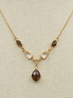 Gold:  9ct Weight:  3.1 grams Gemstone:  Smoky quartz, Rock quartz Size:  16 inches to 18 inches Condition:  Excellent Vintage Condition A beautiful vintage 9ct gold smoky and rock quartz drop necklace. It features 5 faceted quartz gemstones in a Y shape.  It's lightweight, impactful and catches the eye.  The gems are in excellent condition and sparkle under the light.  The chain is adjustable from 16 inches to 18 inches to allow for different necklines.  The largest quartz stone is 10mmx 8mm. This is in excellent vintage condition.  It is stamped 375, fully hallmarked Please read our FAQs for more information on our listings Luxury Brown Gemstone Necklace, Elegant Brown Faceted Necklace, Elegant Gold Smoky Quartz Necklace, Gold Smoky Quartz Gemstone Jewelry, Different Necklines, Brown Smoky Quartz Gemstone Jewelry, Smoky Quartz Necklace, Stone Gold, Quartz Necklace