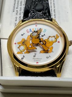 This Garfield Armitron Quartz black leather watch is a Garfield collectors must have! There are 3 dancing Garfields and black music notes on the face of the watch. Garfield's name is also printed in rainbow colors on the face. This watch is preowned but not used. It is in the original Armitron box. A battery is required. The watch is under Armitron's lifetime warranty.  For context, this preowned item is from my mother in law's Garfield collection. She had an enormous Garfield collection, over 40yrs in the making. Many of the items in her collection were displayed in a bedroom dedicated to Garfield memorabilia. Most items were found in their original packaging, and unused. However, given the size and variety of her collection, I can't say how or where specific items were displayed or store Garfield Collection, Black Leather Watch, Black Music, Saint Louis, My Mother, Wrist Watches, Music Notes, Rainbow Colors, Leather Watch