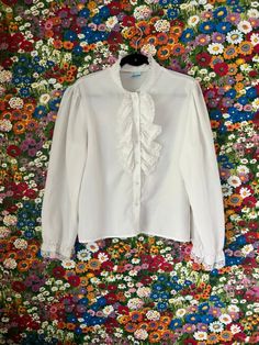 ♡ Vintage 70s/80s White Blouse Look Inc. Ruffle Button Down Peasant Pirate Blouse ♡ ❤ Lightweight white long sleeved button down blouse with ruffle collar. Sleeves ruffle at the wrists. Fabric has a smooth, cottony texture. DETAILS ❥ Size: No tags; ~Medium/Large ❥ Length: 23 inches ❥ Width: 22 inches ❥ Material: Cotton ❣ Brand: The Blouse Look Inc. ❣ No real visible signs of wear -- though I might have missed one! ❣ Previously owned/vintage/worn Pirate Blouse, White Button Up Blouse, Ruffle Shirt, White Button Up, Ruffle Collar, Vintage Wear, White Blouse, Vintage 70s, Womens Clothing Tops