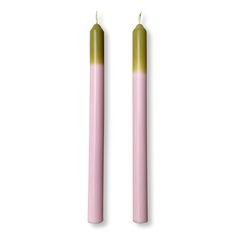 two pink candles sitting next to each other