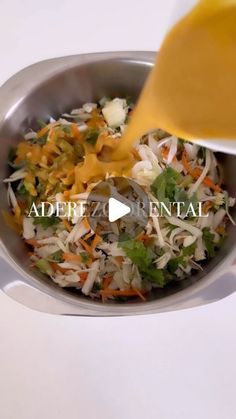 someone pouring dressing into a salad in a bowl