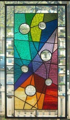 a multicolored stained glass window with circles