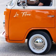 an orange and white vw bus with the word la tite written on it