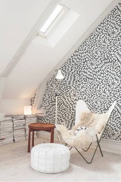 a chair and ottoman in an attic room