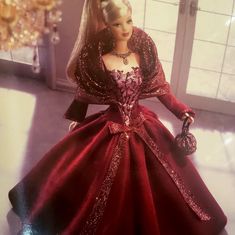 a barbie doll dressed in a red gown