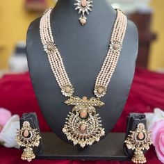 The Ira Necklace Set by Vama Designs is a showstopper and apt for adding royalty to any wedding or festive look. The set has a multi-layered pearl necklace with detailed work on it, complemented perfectly with Jhumar and statement earrings and a matching maang tikka. Delicate craftsmanship in a soft pastel tone makes this set apt for traditional and modern outfits, bringing in that elegance and sophistication into your outfit. Key Features: Multi-Layered Pearl Necklace: This beautiful piece comp Elegant Designer Jhumkas For Festive Occasions, Elegant Designer Festive Jhumkas, Festive Elegant Designer Jhumkas, Elegant Designer Chandbali Jhumkas, Elegant Designer Stone Work Jhumkas, Elegant Jhumkas With Intricate Design For Designer Wear, Elegant Heavy Jhumkas For Designer Wear, Elegant Pearl Jewelry With Meenakari, Festive Designer Jewelry Sets With Stone Work