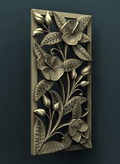 an intricately designed wall panel with flowers and leaves in gold on a dark green background