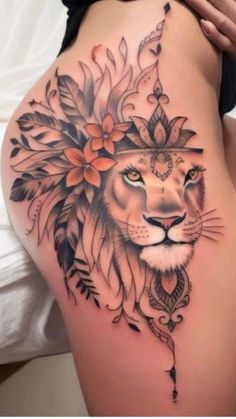 a woman's thigh with a lion and flowers on the side, in black and white