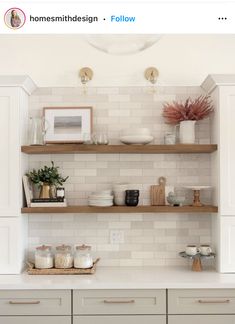 a kitchen with white cabinets and open shelves