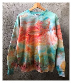 a colorful sweatshirt hanging on a hanger