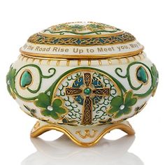 an ornate urn with a cross painted on it