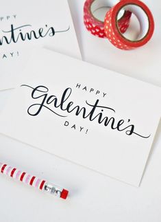 two valentine's day greeting cards with red and white striped tape next to each other