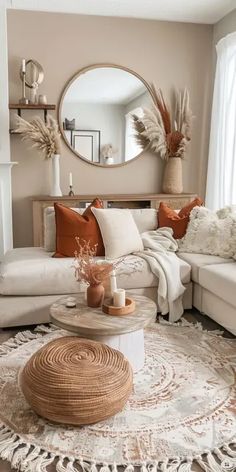 a living room filled with furniture and a large mirror on the wall above it's fireplace