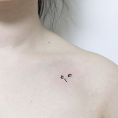 a woman's chest with two small eyes on it