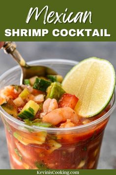 mexican shrimp cocktail in a glass with lime and cilantro garnish on the side