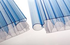 two blue sheer curtains hanging from the side of a window with an arrow pointing to them