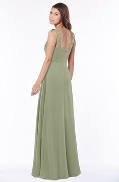 a woman in a long green dress is looking back at the camera with her hand on her hip