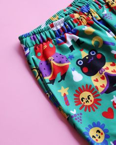 a close up of a child's pants on a pink and blue background with an animal print