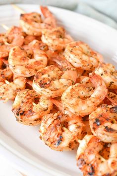 grilled shrimp skewers on a white plate