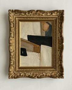 an abstract painting hanging on the wall in a gold frame with black and white designs