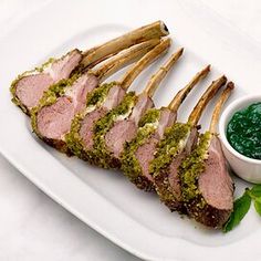 a white plate topped with meat and green sauce