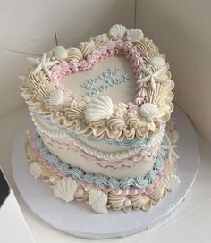 a heart shaped cake with seashells on it