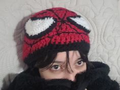 a woman wearing a red and white crocheted beanie with eyes wide open