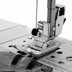 the sewing machine is being used to sew on fabric or other material that has been stitched together