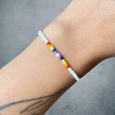 Simple pride bracelet  To order: For a snug fit, order your exact size.  For a looser fit, order one or two sizes up. White Hypoallergenic Friendship Bracelets For Everyday, Rainbow Casual Bracelets For Everyday, White Wristband For Everyday Use, Casual White Bracelets For Friendship, White Round Beaded Wristband For Friendship, Everyday White Beaded Wristband, Casual White Bracelets For Everyday Wear, Casual White Hypoallergenic Wristband, Casual White Wristband For Everyday