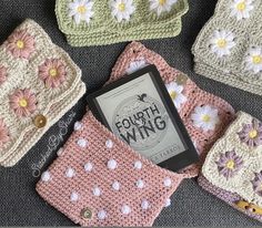 there are four crocheted bags with flowers on them and one has a book in it