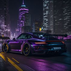 a purple sports car parked in front of a city at night