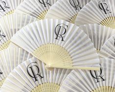 many white fans with the letters q and r on them are arranged in a pattern