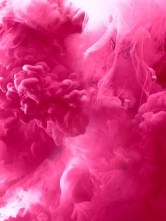 pink and white ink is mixed together in water