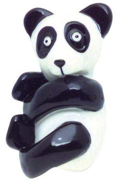 a black and white panda bear figurine with its arms folded up in the shape of a heart