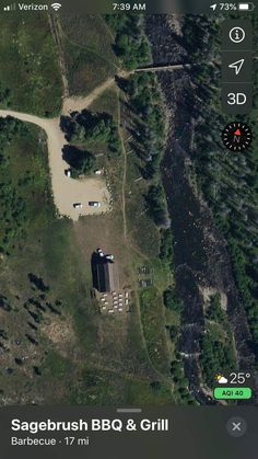 an aerial view of a road and some trees