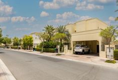 a car parked in front of a building on the side of a street with palm trees