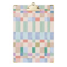 a clipboard with a checkered pattern in pastel colors and gold clips attached to it