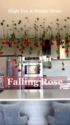 flowers are hanging from the ceiling above a kitchen counter with two chairs and a microwave