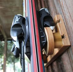 a pair of skis are mounted to the side of a building with wooden slats