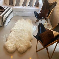 a living room filled with lots of white furniture