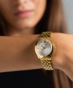 A classic design, elevated. The bold and urban Vivid watch features a statement round face with chunky outer casing that’s juxtaposed by the delicate sunray dial, minimalist numerals and crystal detailing. In elegant yet eccentric gold, silver and white with a 32mm face, Vivid is a powerful piece pairing androgynous design with robust links made of gold-plated metal for effortless sophistication. Timepiece Design, Pretty Watches, Womens Designer Watches, Gold Watches Women, Watch Trends, Large Face, Ladies Watches, Womens Watches Luxury, Jewelry Fashion Trends