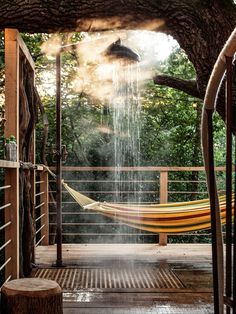 a hammock in the middle of a tree with water coming out of it