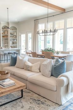 a living room filled with furniture and lots of windows