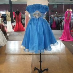 Short Strapless Dress With Ruffle Bodest And Tull Belt With A Cluster Of Gems, And A Puffy Tull Skirt Blue Strapless Dress For Prom, Blue Strapless Dress For Homecoming Prom Season, Light Blue Strapless Dress For Prom, Blue Strapless Dress For Homecoming, Royal Blue Strapless Dress For Prom Season, Royal Blue Strapless Prom Dress, Blue Casual Strapless Dress, Puffy Blue Dress Short, Formal Light Blue Strapless Dress